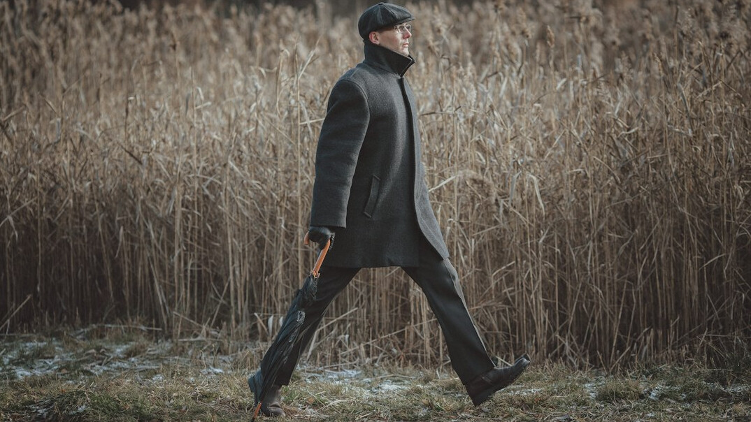 man in dark coat walking